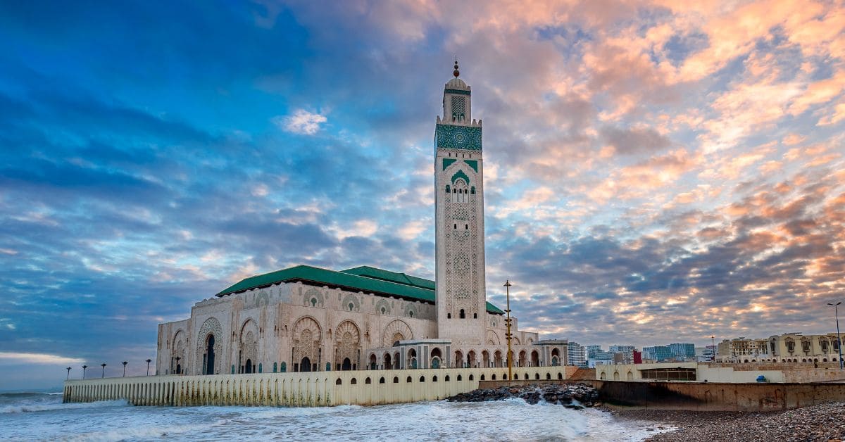 A stunning view of the majestic Casablanca Mosque, showcasing intricate architectural details and the grandeur of this iconic religious landmark.