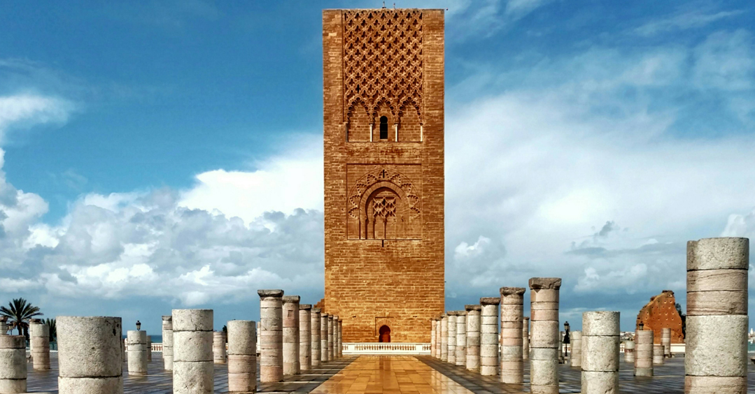 Majestic Hassan Tower against a clear blue sky – Iconic Moroccan landmark with intricate architecture and historical significance.