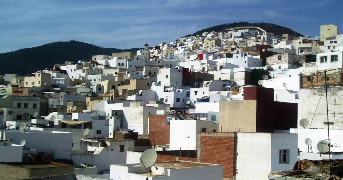 Aerial view of the historic Old Medina of Tetouan, showcasing winding streets, traditional architecture, and vibrant market stalls.