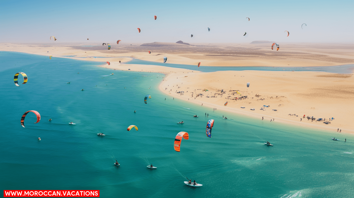 Group of people kiteboarding on the water under a clear blue sky in Dakhla, with mountains in the background.